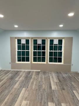 Living room with three newly installed double-hung windows and fresh trim