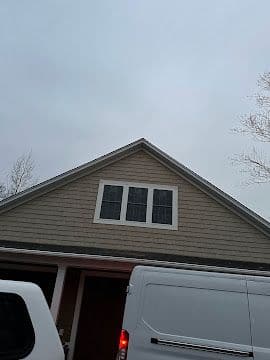 Close view of finished gable siding and window trim work