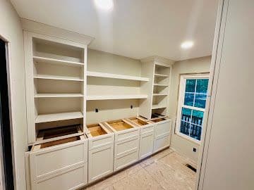 Custom built-in pantry shelving and cabinetry with painted finish