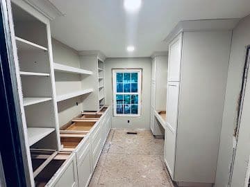 Butler's pantry with floor-to-ceiling built-in shelving and drawer bases